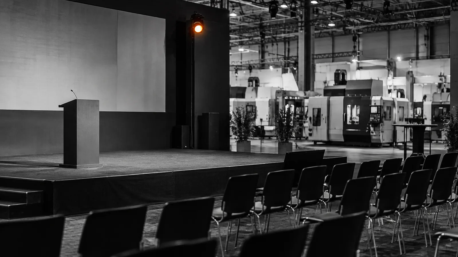 Empty conference stage inside a machine-tool trade show hall